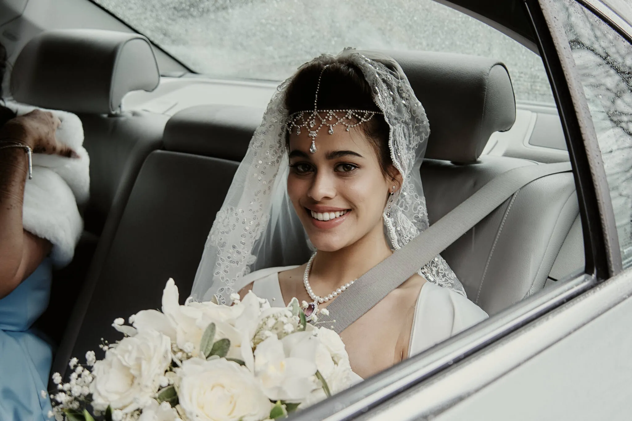 Queenstown New Zealand Elopement Wedding Photographer - Queenstown Islamic Wedding: A bride, Yumn, sitting in the back seat of a car.