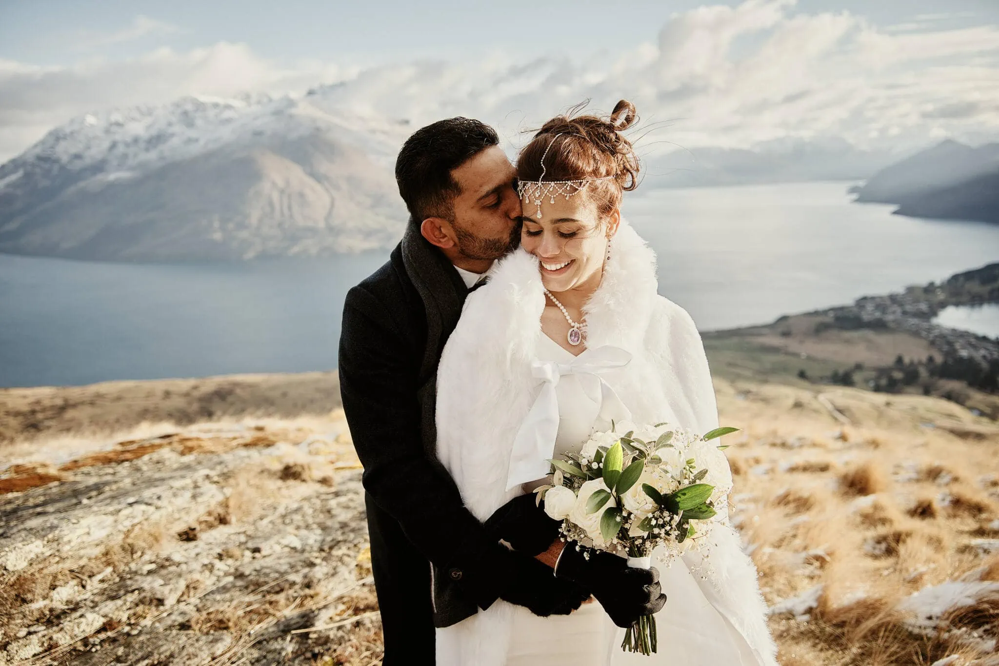 Queenstown New Zealand Elopement Wedding Photographer - A Muslim couple, Wasim and Yumn, sharing a kiss atop a mountain overlooking Lake Wanaka during their Queenstown Islamic wedding.