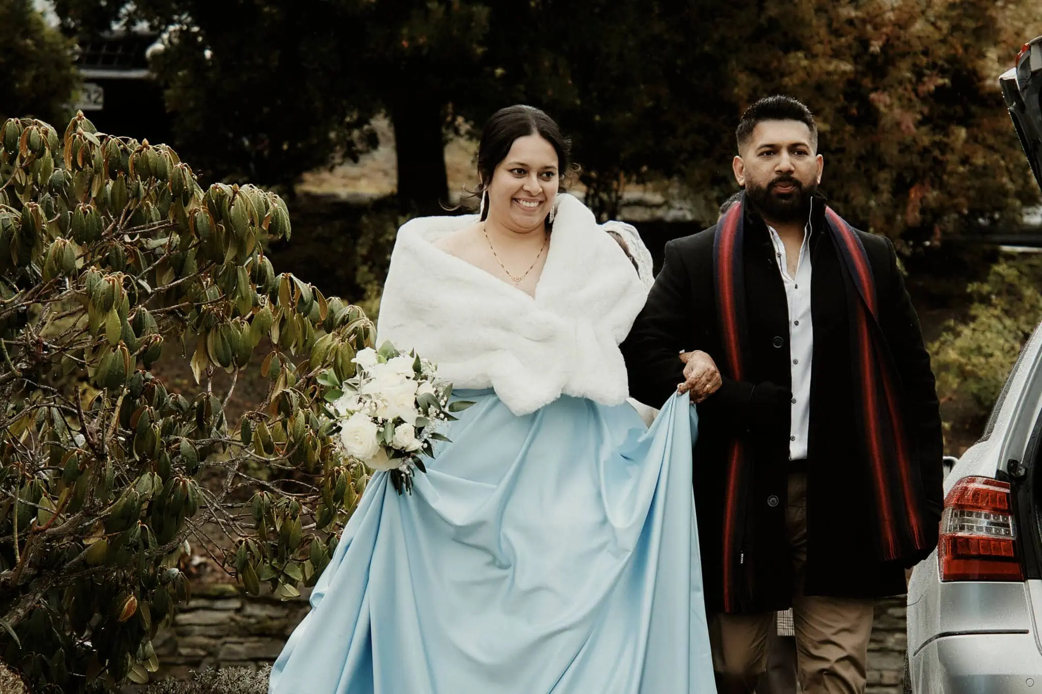 Queenstown New Zealand Elopement Wedding Photographer - Wasim and Yumn, Queenstown Islamic Wedding couple, walking to their car in a blue dress.