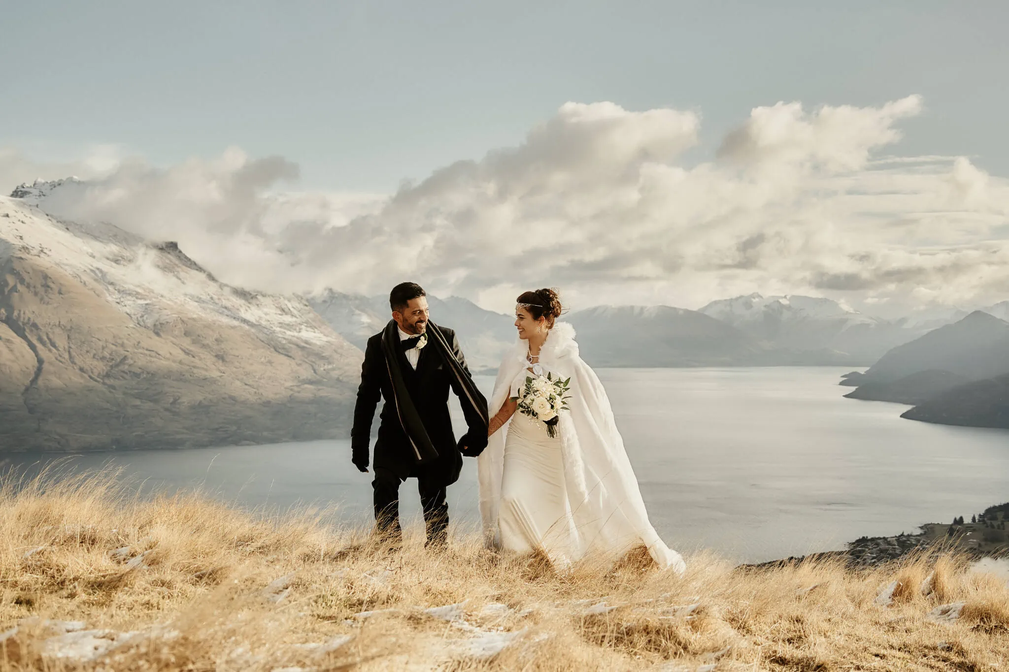 Queenstown New Zealand Elopement Wedding Photographer - Wasim and Yumn, Queenstown Islamic Wedding - A bride and groom standing on top of a hill overlooking Lake Wanaka.