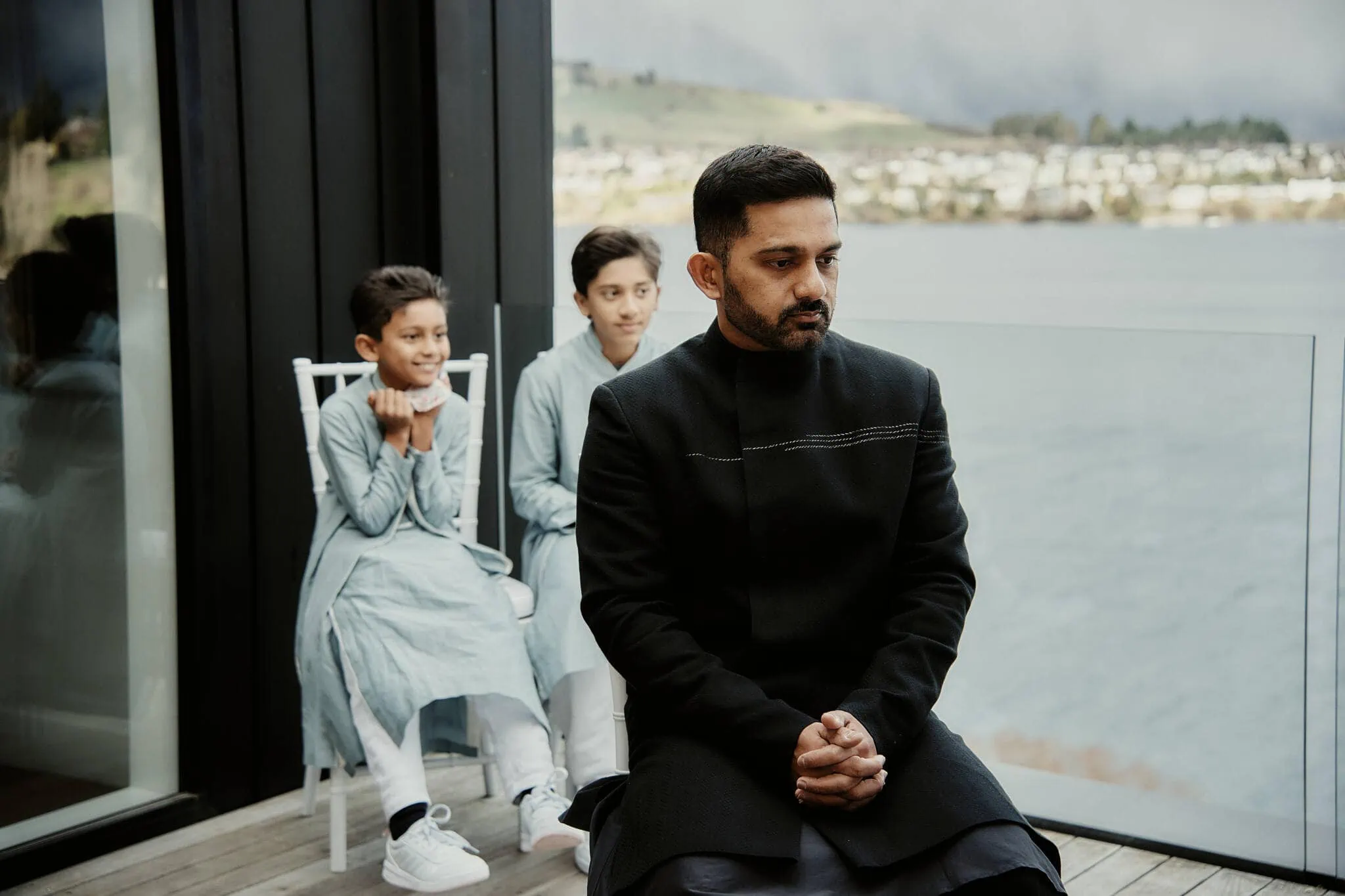 Queenstown New Zealand Elopement Wedding Photographer - During the Queenstown Islamic Wedding, Wasim cherishes a moment on the balcony with his children Yumn.