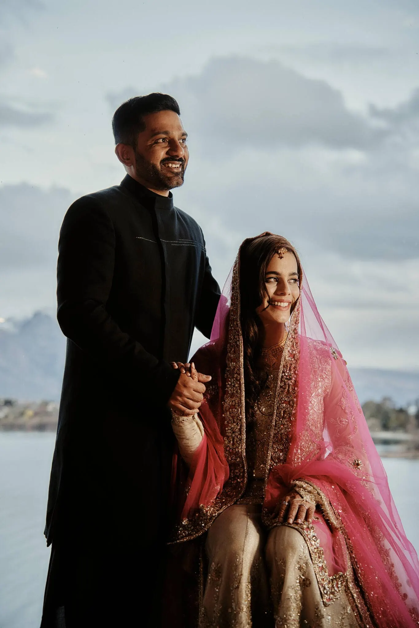 Queenstown New Zealand Elopement Wedding Photographer - Wasim and Yumn, a couple, posing for a photo by the water at their Queenstown Islamic wedding.