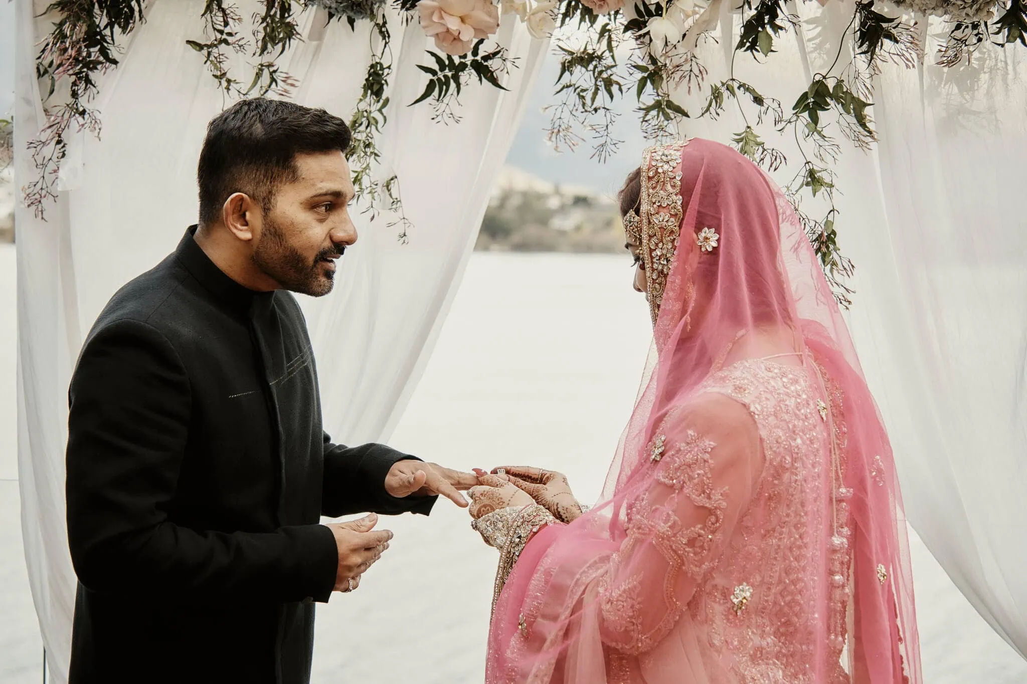Queenstown New Zealand Elopement Wedding Photographer - Wasim and Yumn exchange rings at a lakeside Islamic wedding in Queenstown.