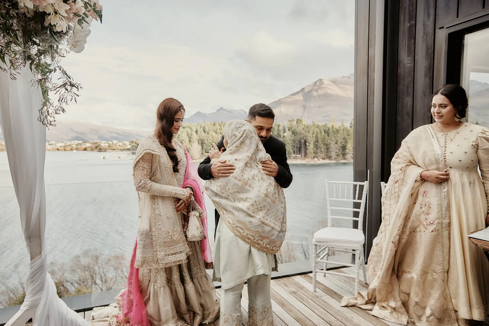 Queenstown New Zealand Elopement Wedding Photographer - Wasim and Yumn's Queenstown Islamic Wedding, with the bride and groom hugging in front of a lake in New Zealand.