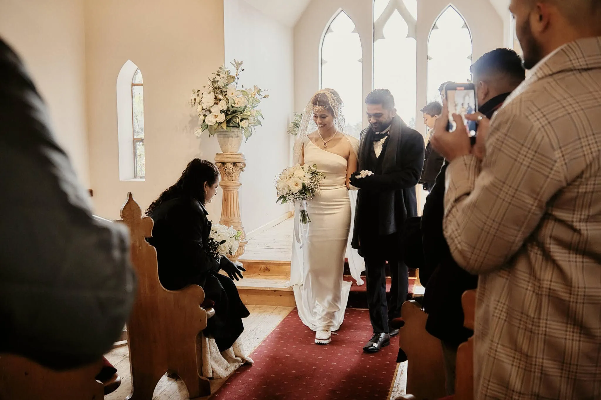 Queenstown New Zealand Elopement Wedding Photographer - Keywords used: bride and groom, walking down the aisle, church

Description modified: Wasim and Yumn walking down the aisle of a church for their Queenstown Islamic wedding.
