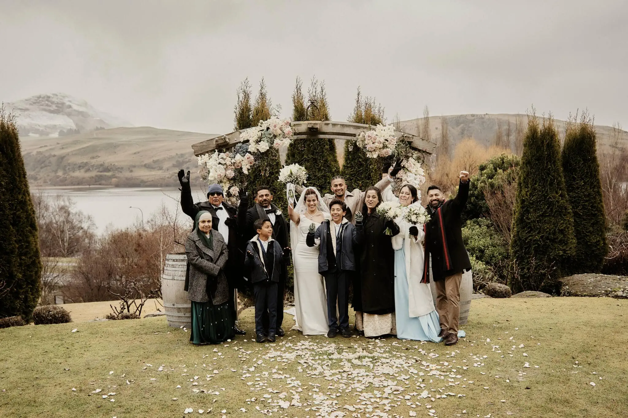 Queenstown New Zealand Elopement Wedding Photographer - Wasim and Yumn, a wedding party, poses for a photo in front of a lake at Queenstown Islamic Wedding.
