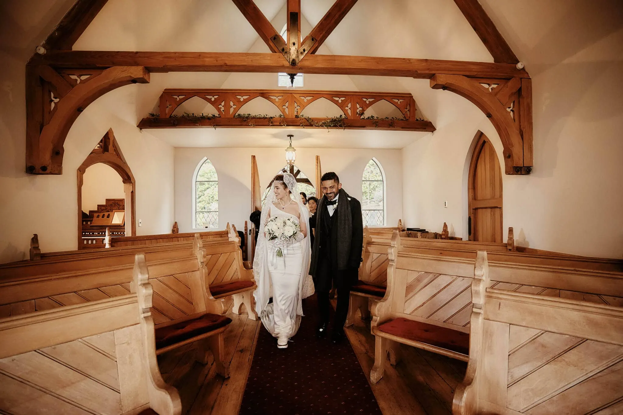 Queenstown New Zealand Elopement Wedding Photographer - Wasim and Yumn's Queenstown Islamic Wedding: A bride and groom walking down the aisle of a church.