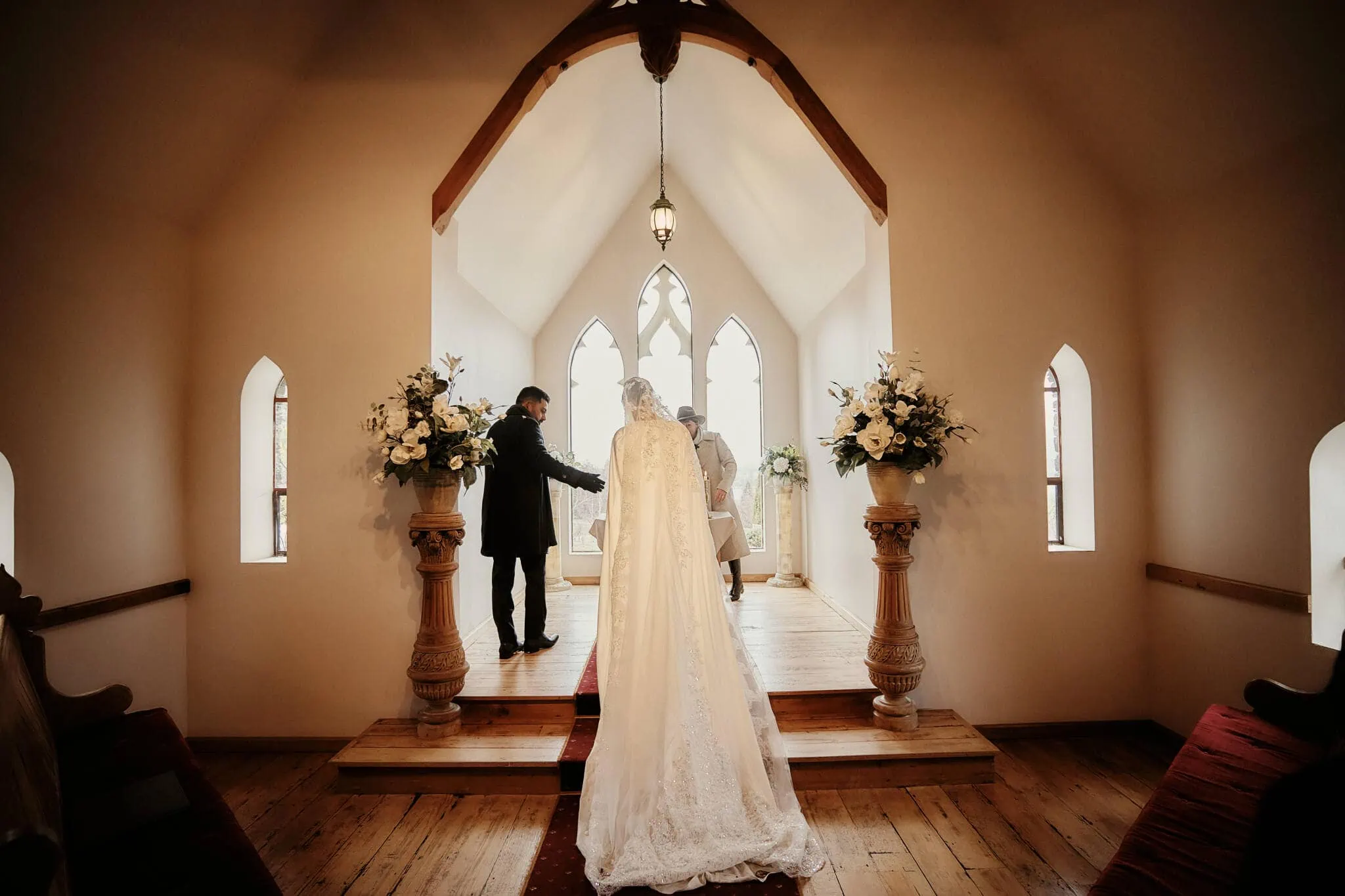 Queenstown New Zealand Elopement Wedding Photographer - Wasim and Yumn's Islamic wedding in Queenstown, with the bride and groom walking down the aisle of a church.