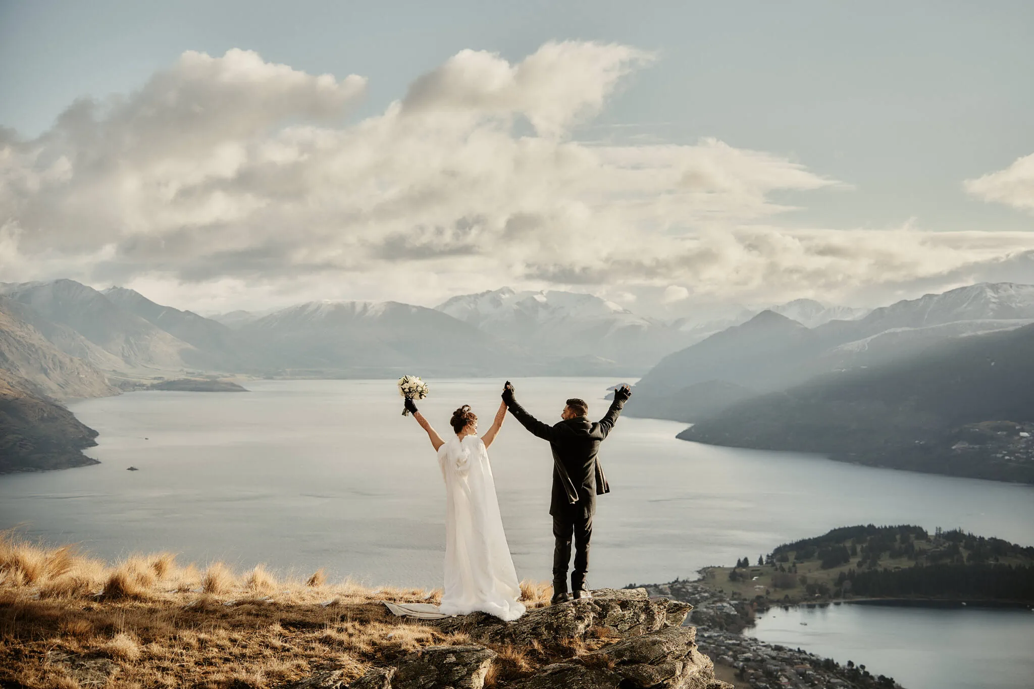 Queenstown New Zealand Elopement Wedding Photographer - Wasim and Yumn, a bride and groom, stand on top of a mountain overlooking Lake Wanaka for their Queenstown Islamic wedding.