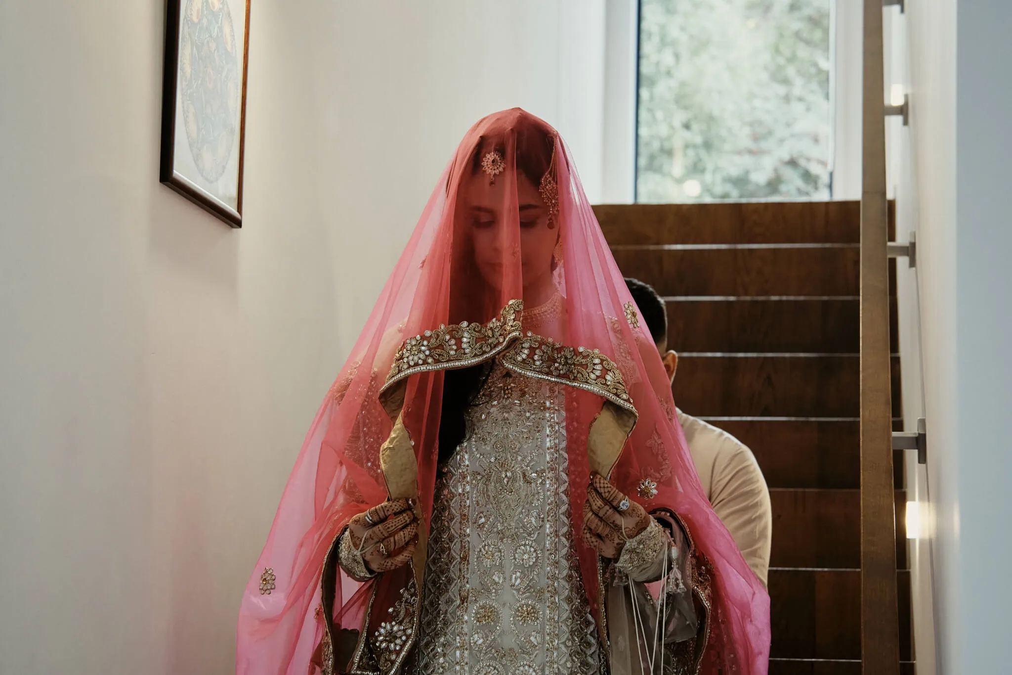 Queenstown New Zealand Elopement Wedding Photographer - A bride in a pink veil walking down the stairs at Wasim and Yumn's Queenstown Islamic Wedding.
