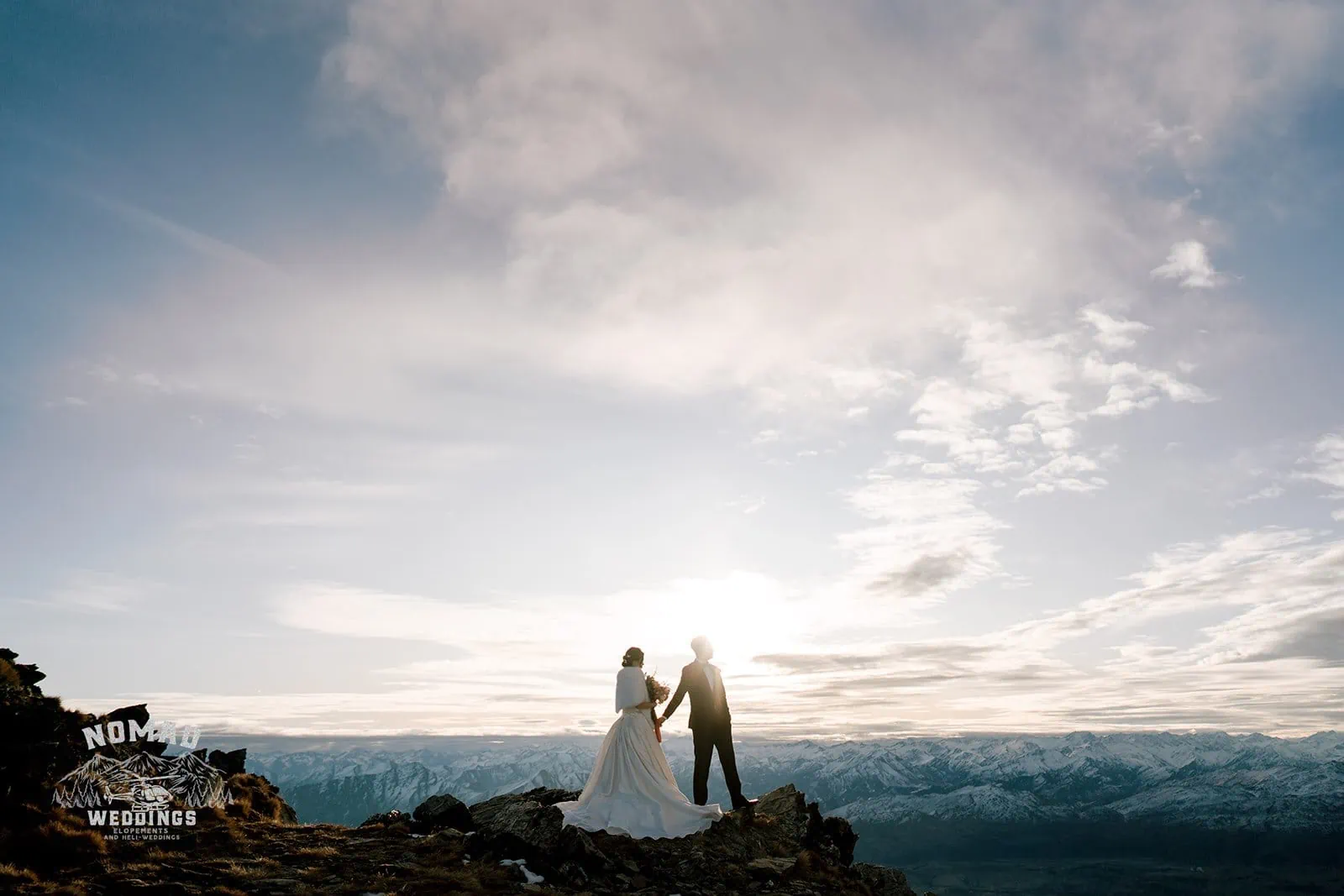 Queenstown New Zealand Elopement Wedding Photographer - A bride and groom, Bo and Junyi, have a heli pre-wedding shoot on a mountain with four landings at sunset.