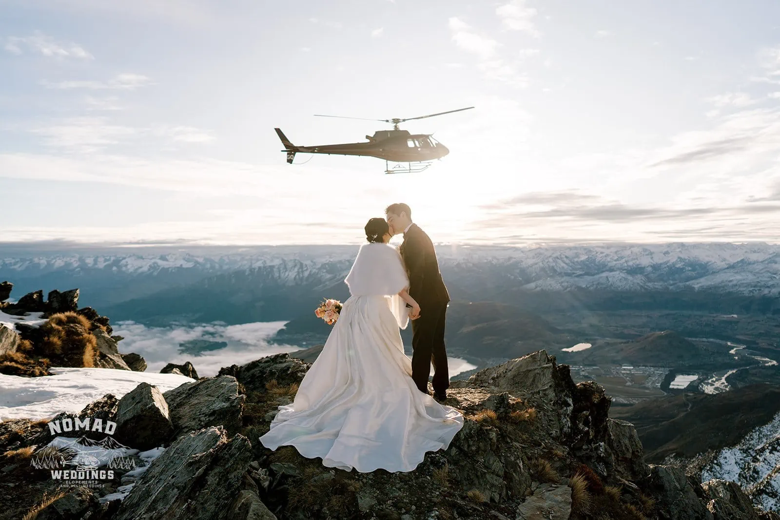 Queenstown New Zealand Elopement Wedding Photographer - A bride and groom, Bo and Junyi, pose on a mountain during their Heli Pre Wedding Shoot with 4 Landings.