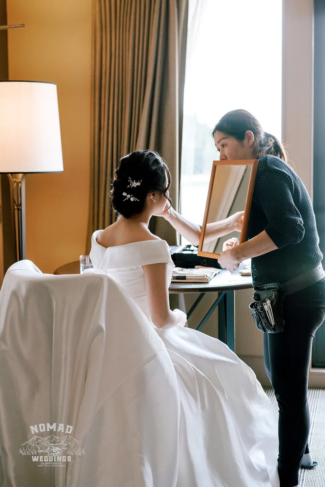 Queenstown New Zealand Elopement Wedding Photographer - A bride getting her makeup done for her Bo and Junyi Heli Pre Wedding Shoot in a hotel room.