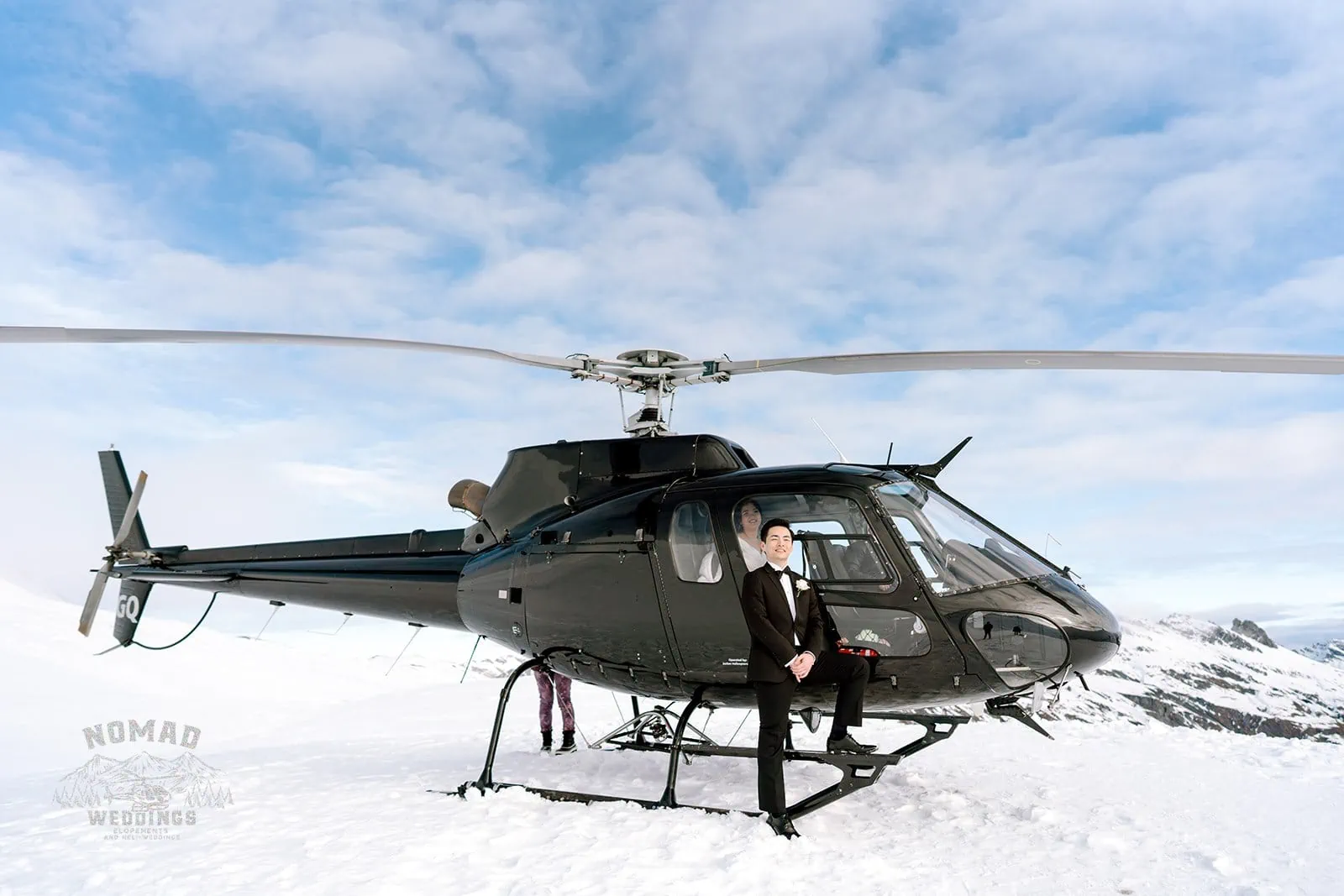 Queenstown New Zealand Elopement Wedding Photographer - Bo and Junyi pose with a helicopter during their snowy pre-wedding shoot, featuring 4 awe-inspiring landings.