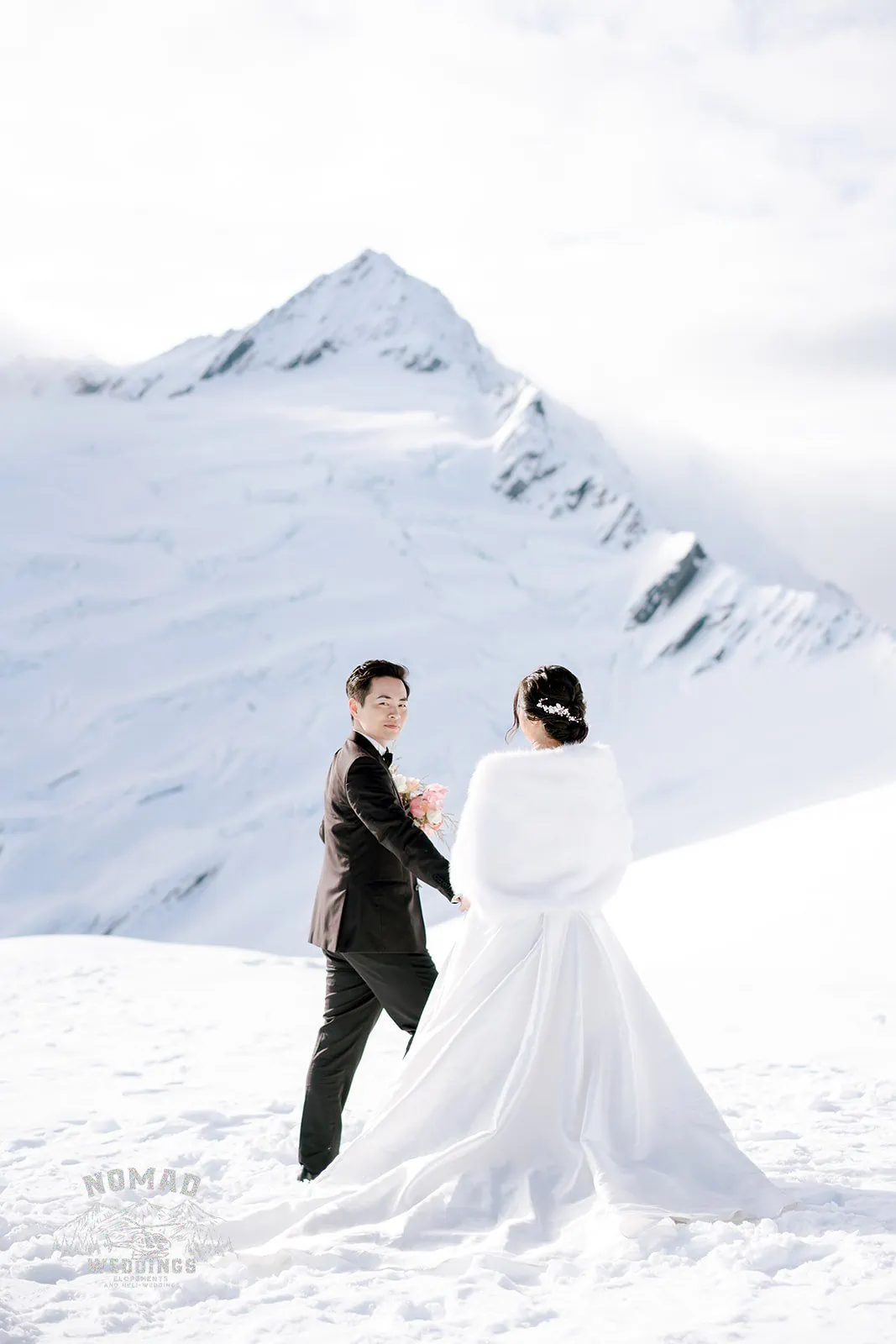 Queenstown New Zealand Elopement Wedding Photographer - A bride and groom, Bo and Junyi, have a breathtaking Heli Pre Wedding Shoot on a snow covered mountain with 4 landings.
