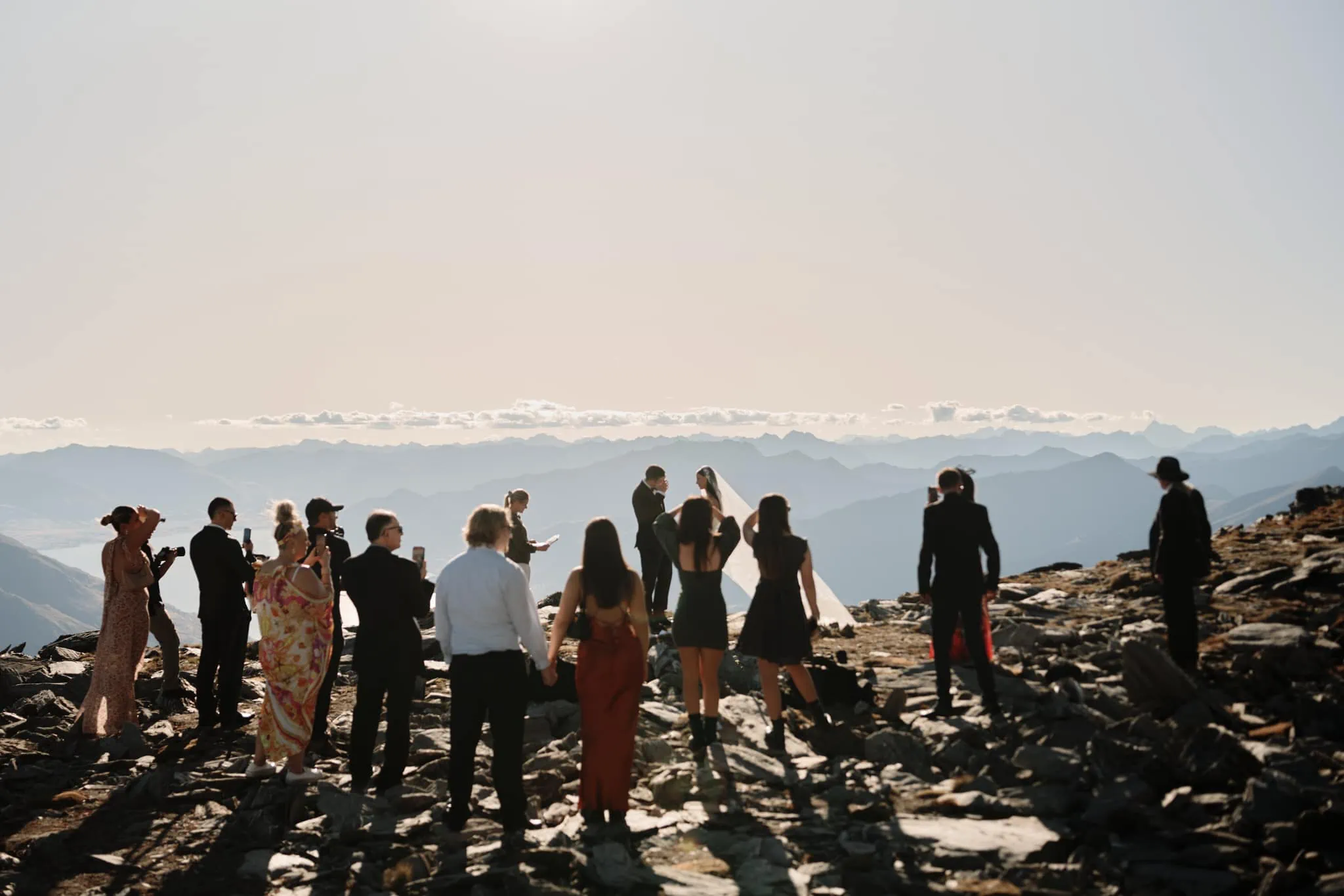 Queenstown New Zealand Elopement Wedding Photographer - A group of people reaching a mountain summit.