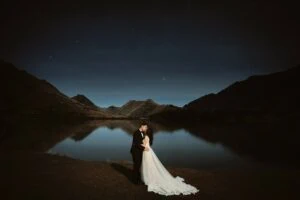 Queenstown New Zealand Elopement Wedding Photographer - A bride and groom having a romantic Starry Night Shoot at a lake.