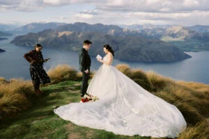 Queenstown New Zealand Elopement Wedding Photographer - Josh and his bride stood on top of a mountain, enjoying the breathtaking view of Lake Wanaka.