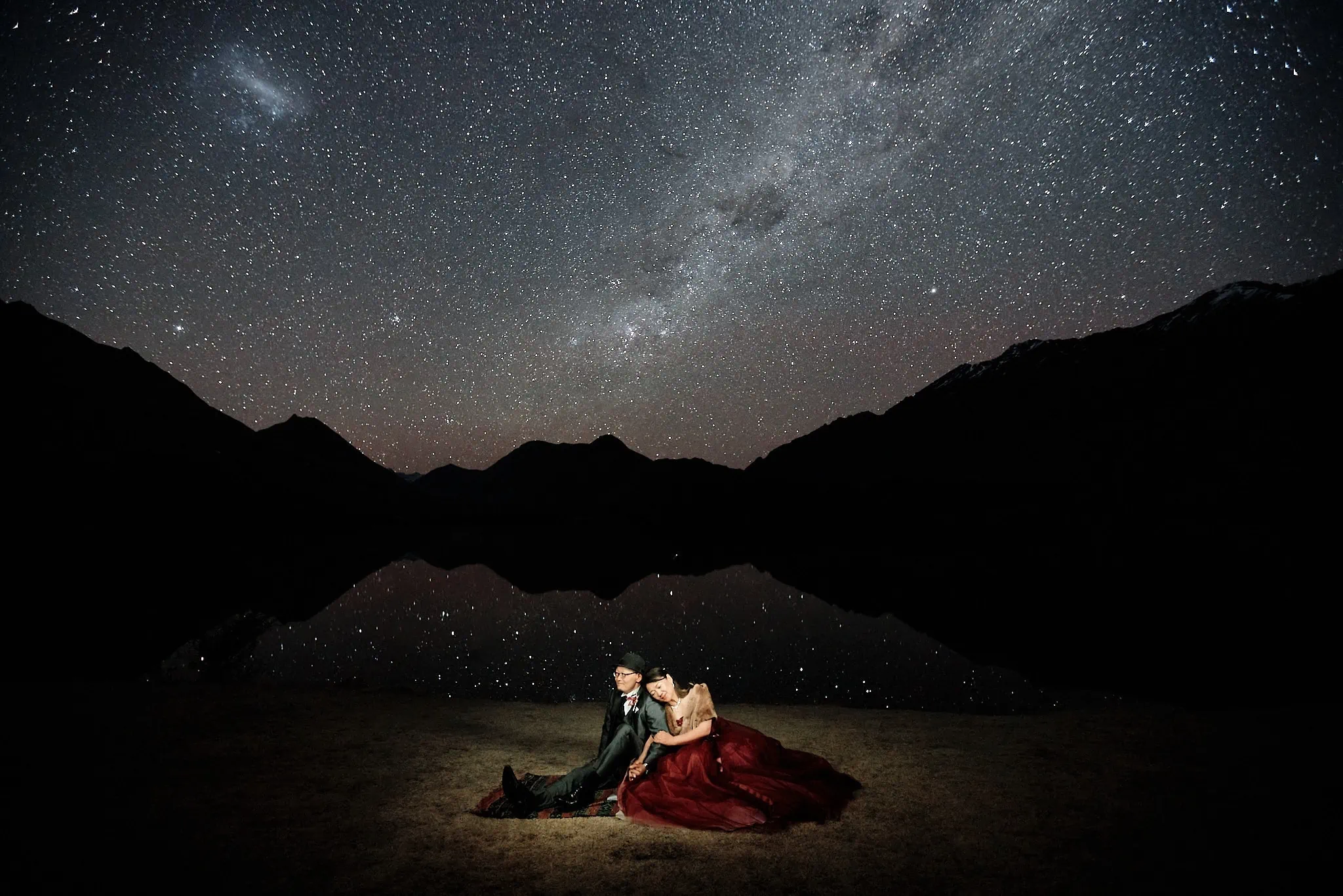 Queenstown New Zealand Elopement Wedding Photographer - A bride and groom enjoying a romantic starry night on a lake for their portfolio shoot.