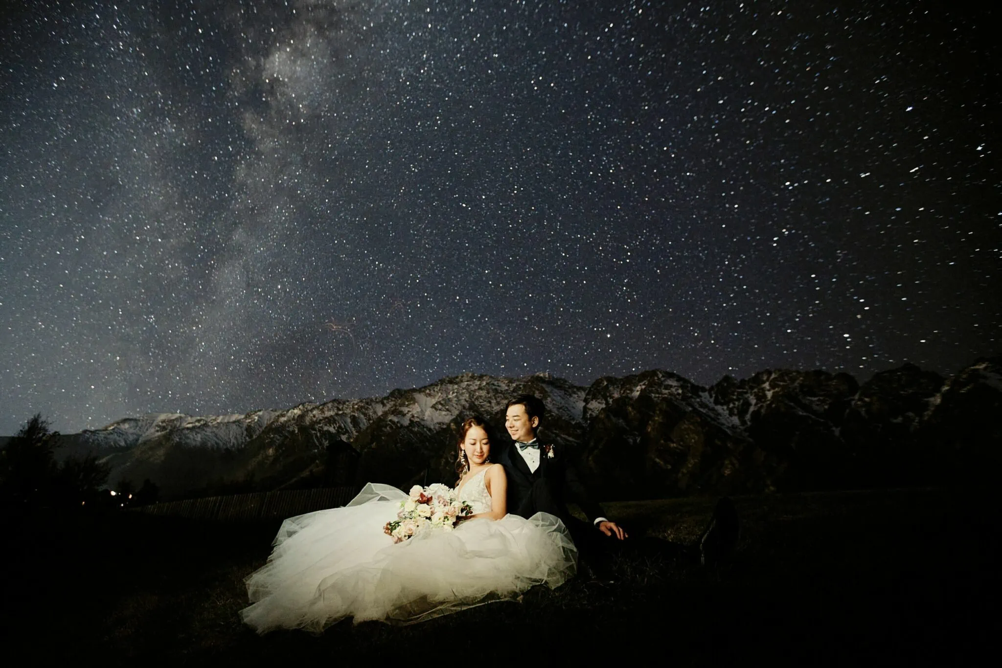 Queenstown New Zealand Elopement Wedding Photographer - A couple sitting under a starry sky, captured in our Starry Night Shoot portfolio.