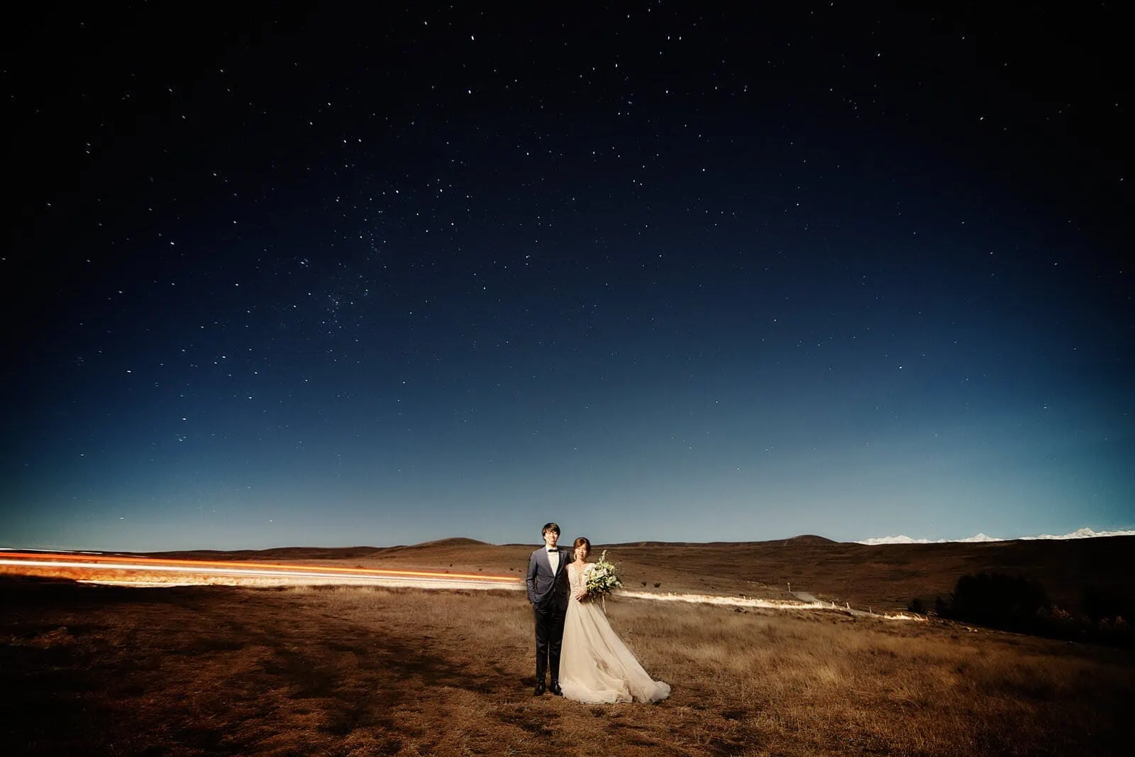 Queenstown New Zealand Elopement Wedding Photographer - A stunning Starry Night Shoot capturing a radiant bride and groom under the enchanting starry sky, adding a breathtaking scene to their photography portfolio.