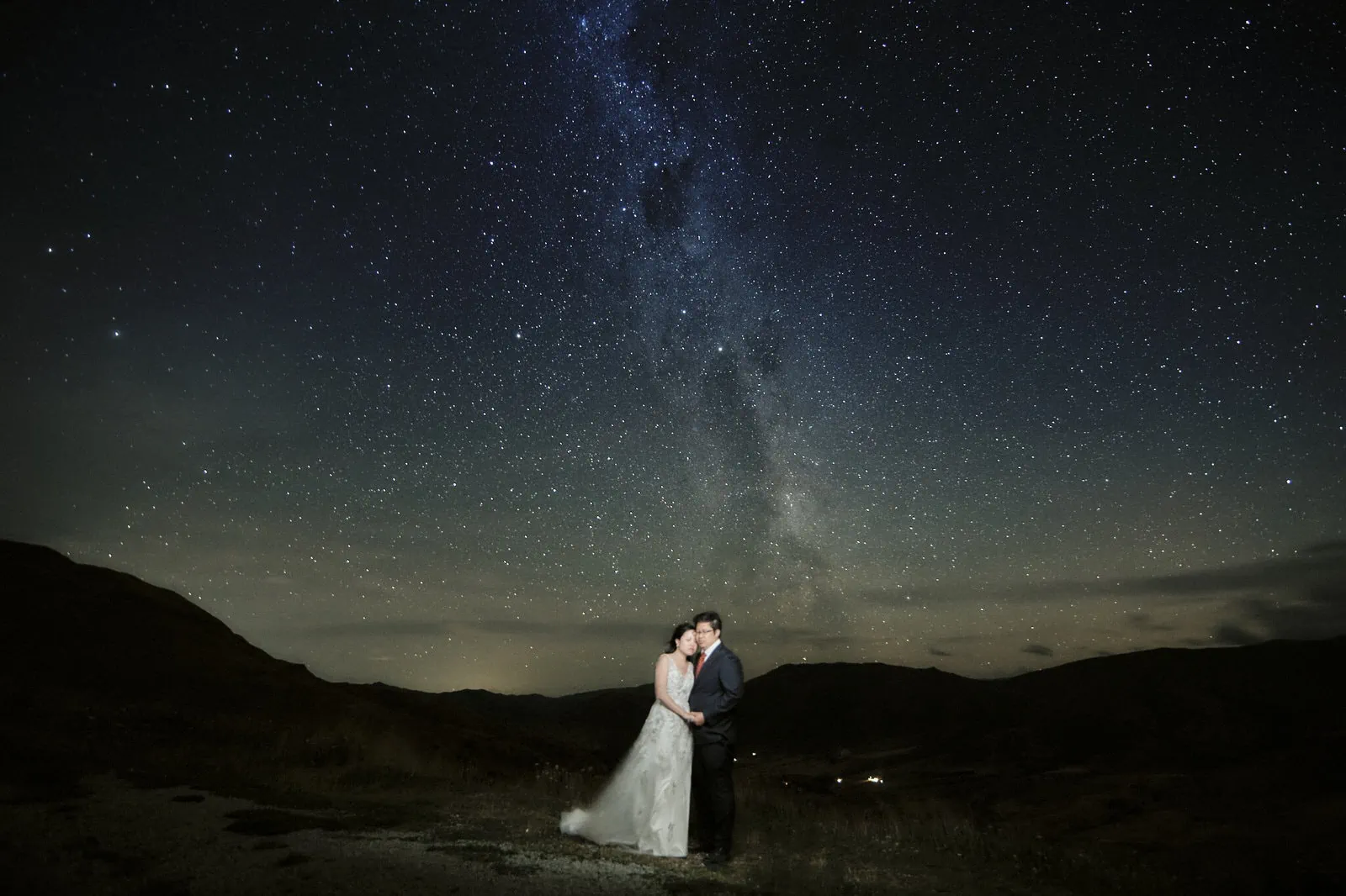 Queenstown New Zealand Elopement Wedding Photographer - A bride and groom posing for a Starry Night Shoot under a starry sky.