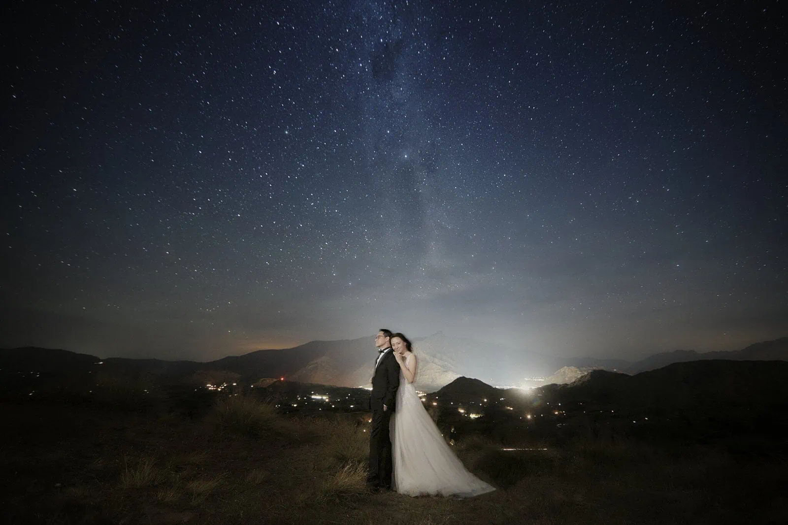 Queenstown New Zealand Elopement Wedding Photographer - A bride and groom posing for a starry night shoot under the milky way, adding to their exquisite portfolio.