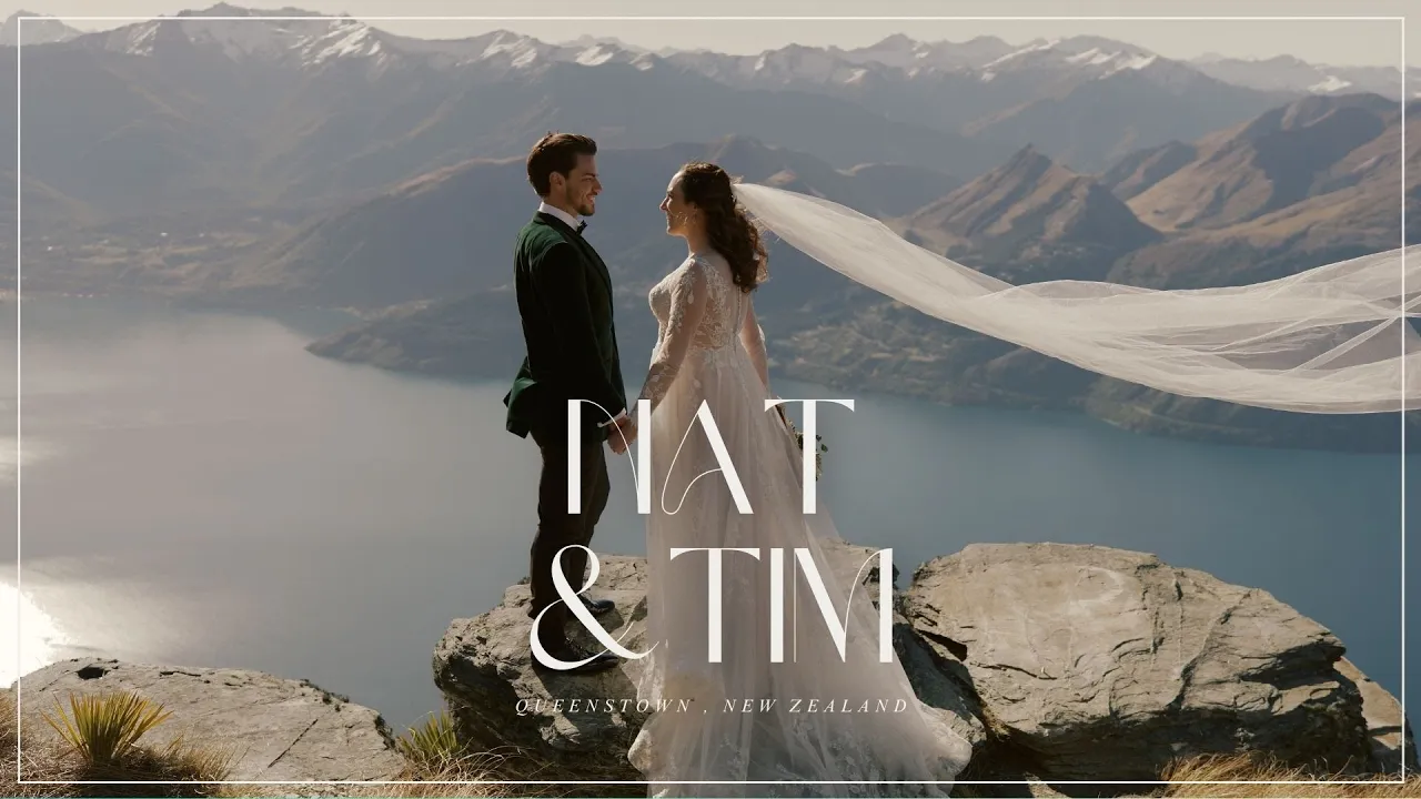 Queenstown New Zealand Elopement Wedding Photographer - Ayaka, a wedding photographer based in Queenstown, captures a beautiful moment of a bride and groom standing in front of a waterfall.