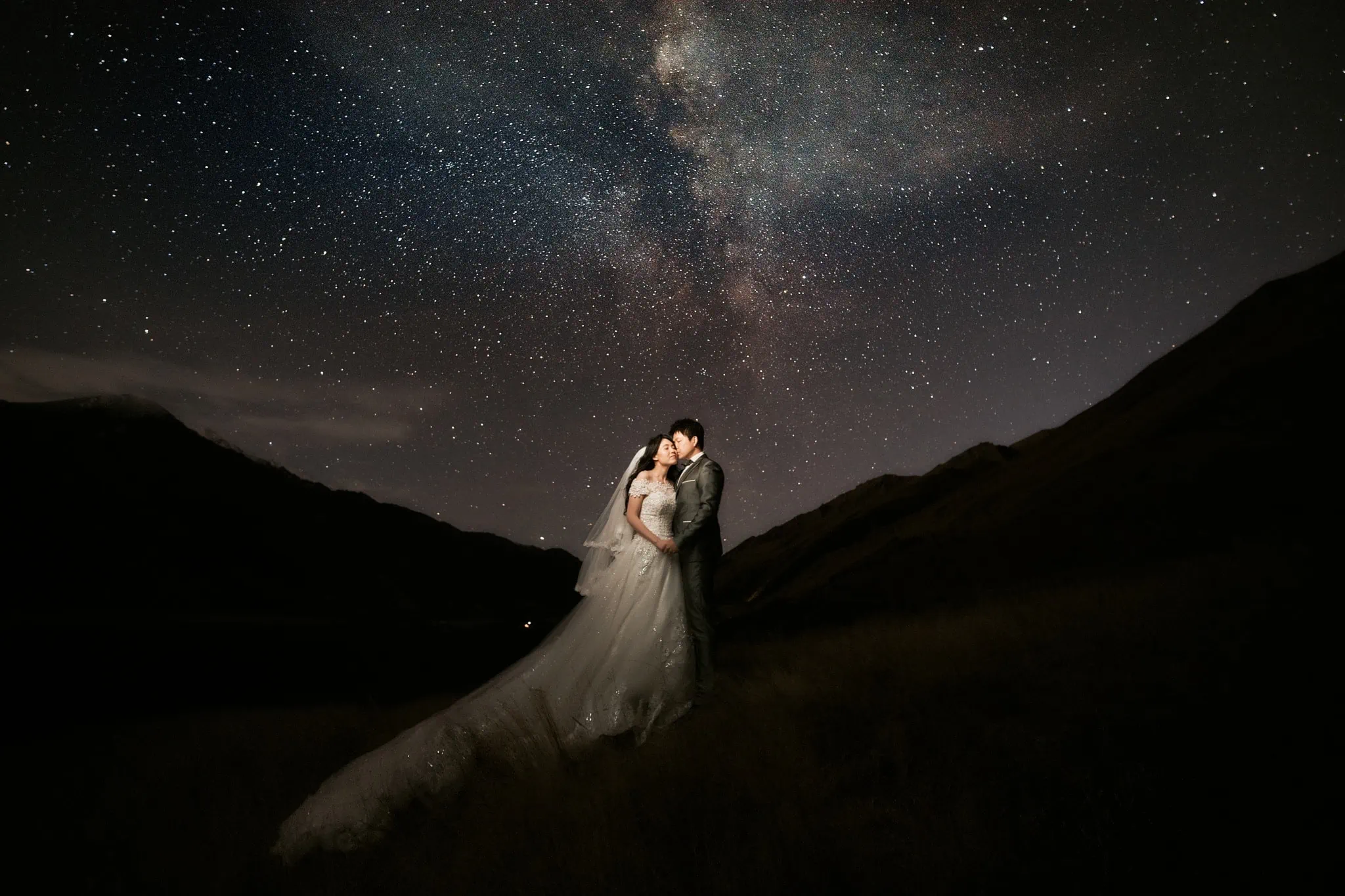 Queenstown New Zealand Elopement Wedding Photographer - A breathtaking Starry Night Shoot of a bride and groom standing under the milky way, showcased in our portfolio.