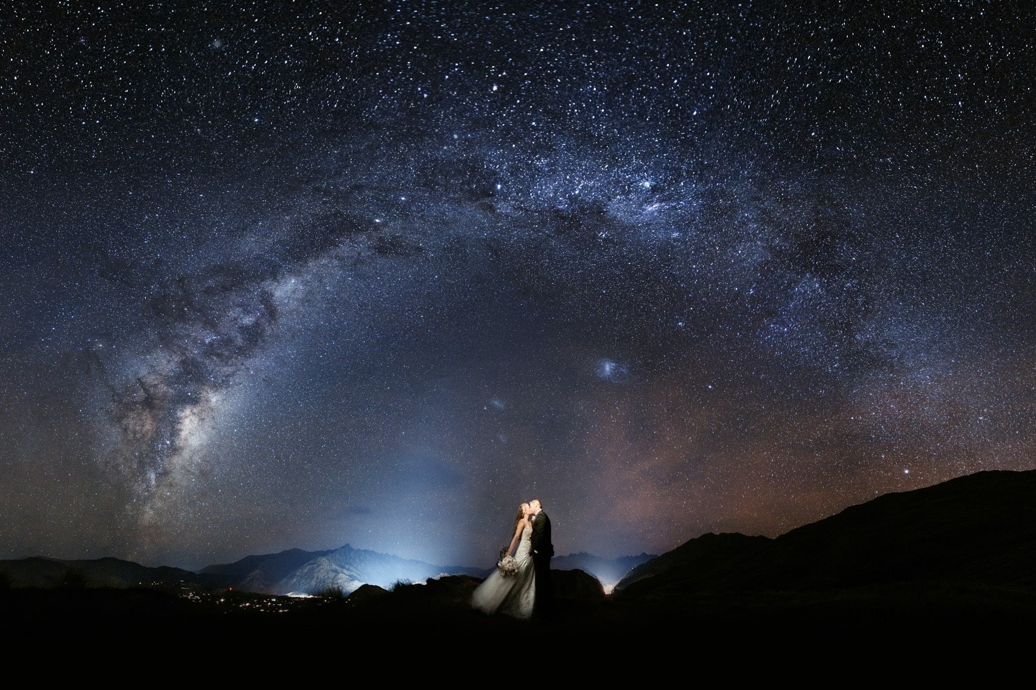 Queenstown New Zealand Elopement Wedding Photographer - A bride and groom standing under the starry night sky.