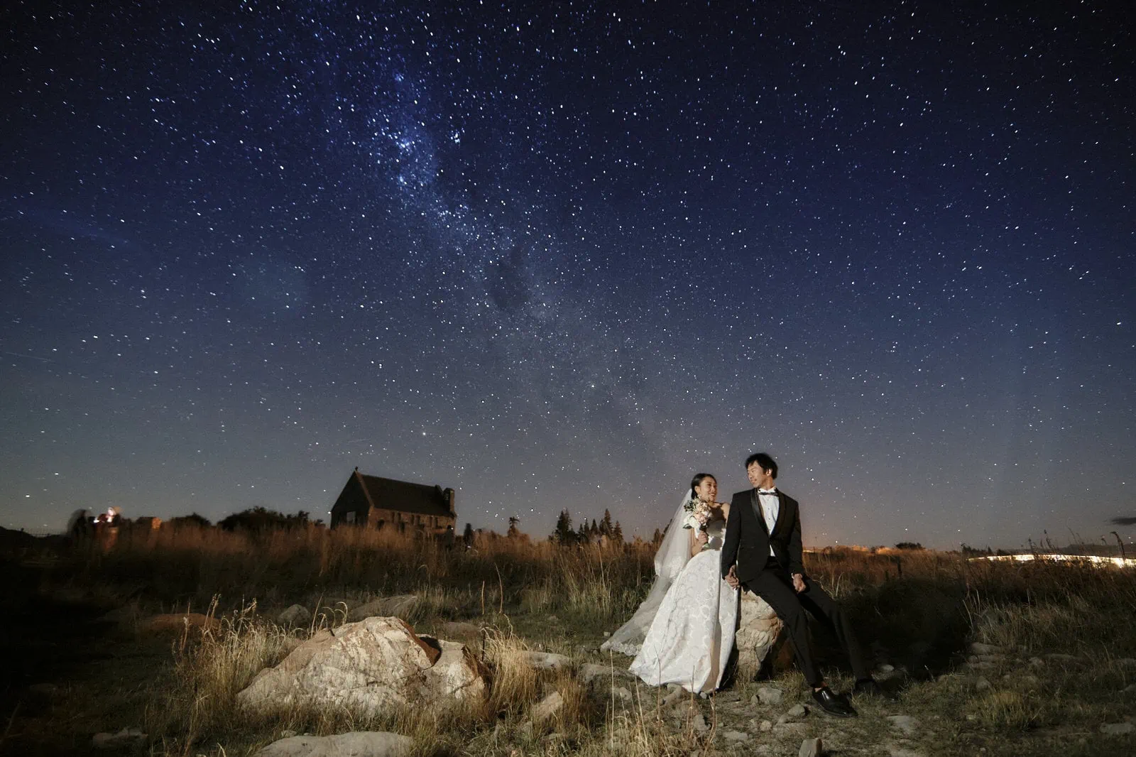 Queenstown New Zealand Elopement Wedding Photographer - A bride and groom posing under a starry sky for their Starry Night Shoot portfolio.