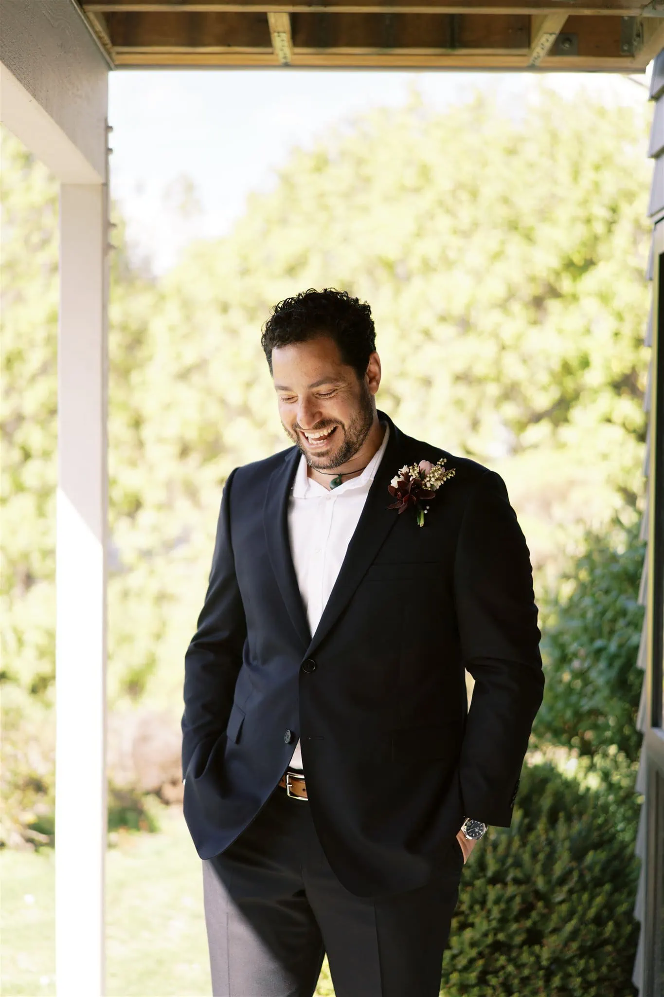Queenstown New Zealand Elopement Wedding Photographer - A groom in a suit standing on a porch in Queenstown.