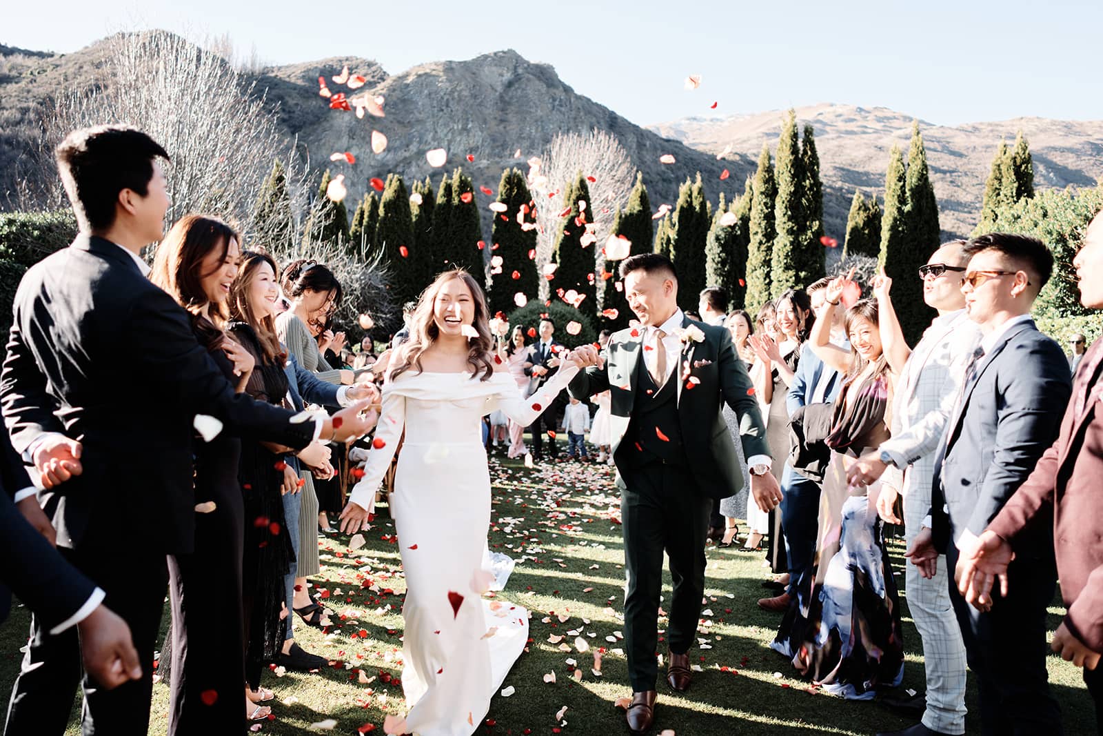 Queenstown New Zealand Elopement Wedding Photographer - Tom and Lindy have an intimate elopement wedding as they joyfully walk down the aisle with confetti thrown at them.