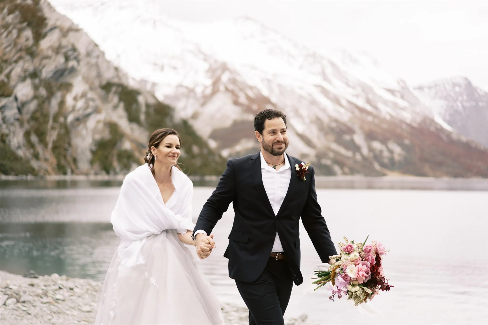 Queenstown New Zealand Elopement Wedding Photographer - A bride and groom stargazing by a lake in Queenstown, with mountains in the background.
