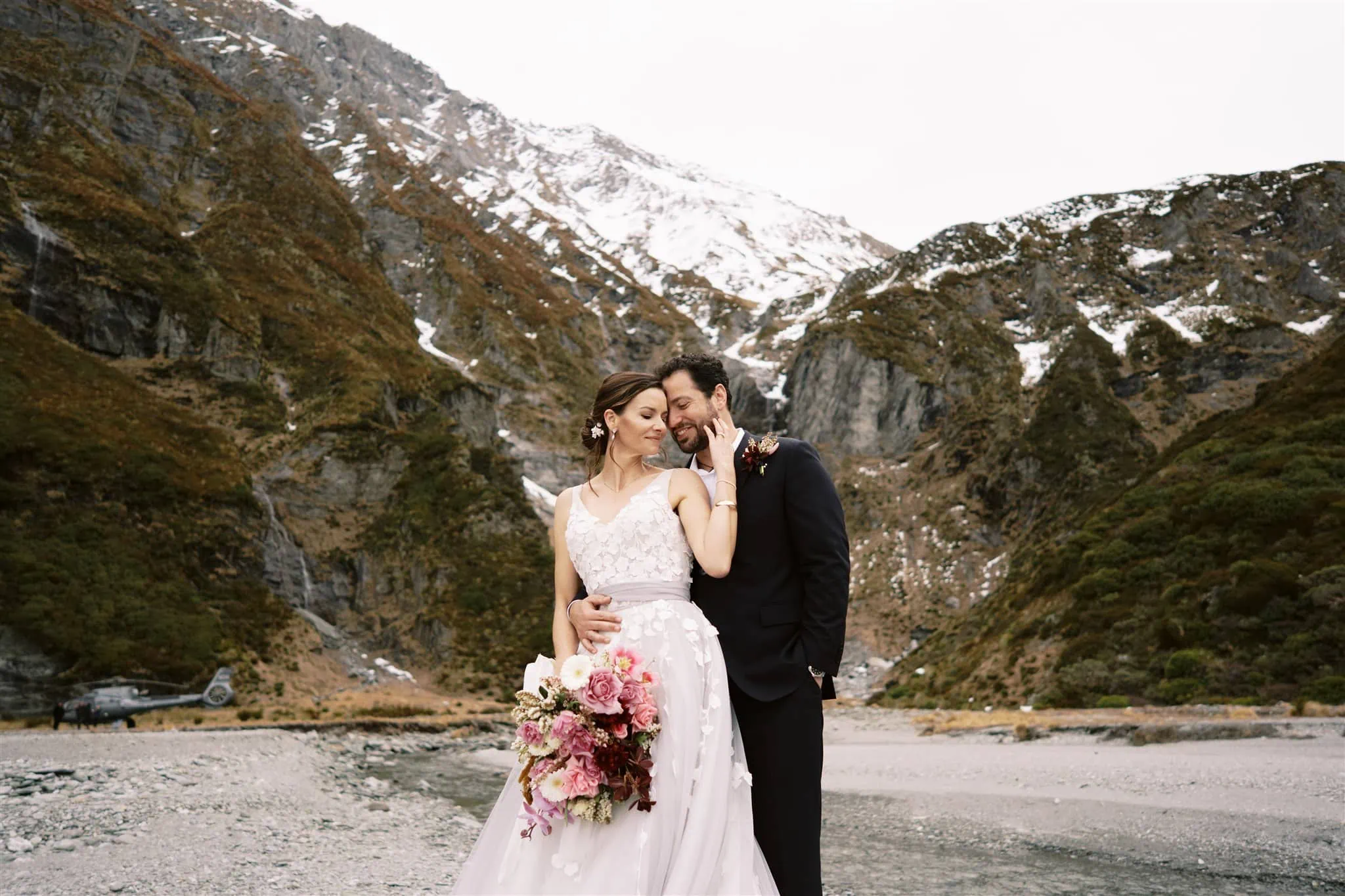 Queenstown New Zealand Elopement Wedding Photographer - A bride and groom elopement in Queenstown, New Zealand, standing in front of a river while stargazing.