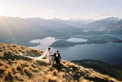 Queenstown New Zealand Elopement Wedding Photographer - Bride and groom enjoying a stunning view of Lake Wanaka during their Queenstown heli-wedding package.