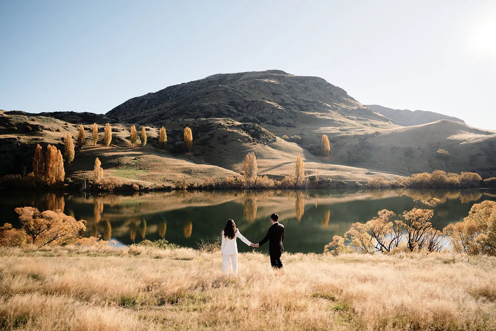 Queenstown New Zealand Elopement Wedding Photographer - A bride and groom exchanging vows at a scenic lakefront Queenstown wedding venue.