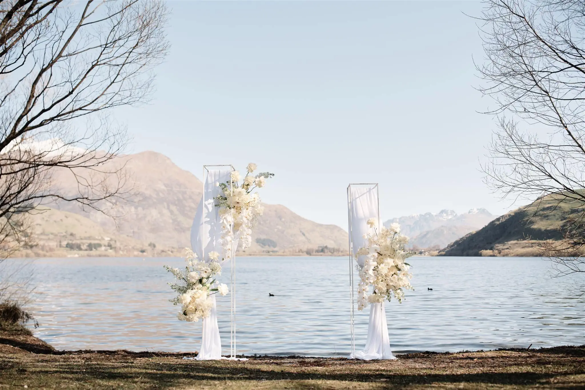 Queenstown New Zealand Elopement Wedding Photographer - A queenstown wedding ceremony in front of a lake in New Zealand.