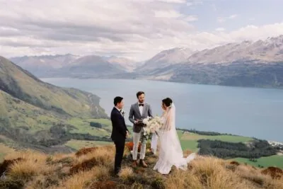 Queenstown New Zealand Elopement Wedding Photographer - A bride and groom standing on top of Mt Creighton overlooking lake wakatipu