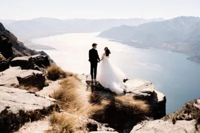 Queenstown New Zealand Elopement Wedding Photographer - Bride and groom standing on top of Cecil Peak, overlooking Lake Wanaka.