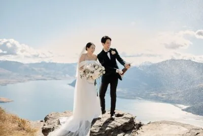 Queenstown New Zealand Elopement Wedding Photographer - A bride and groom standing on top of Cecil Peak in New Zealand.