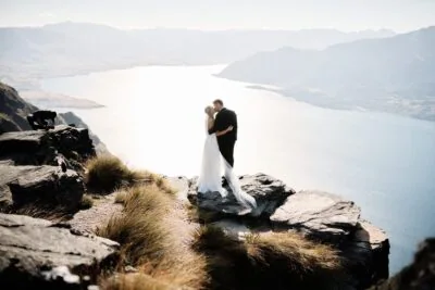 Queenstown New Zealand Elopement Wedding Photographer - Bride and groom standing on top of Cecil Peak, overlooking Lake Wanaka.