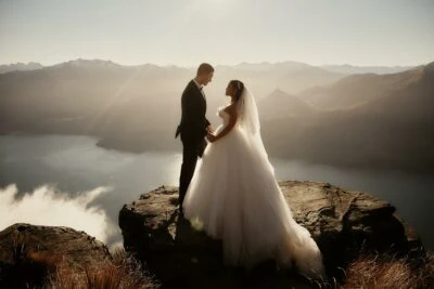 Queenstown New Zealand Elopement Wedding Photographer - A bride and groom standing on top of Cecil Peak overlooking Lake Wanaka.