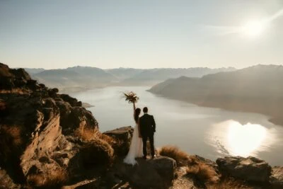 Queenstown New Zealand Elopement Wedding Photographer - Bride and groom standing on top of Cecil Peak overlooking lake wanaka.