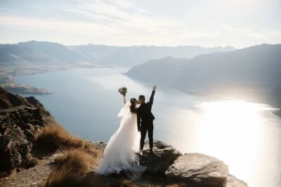 Queenstown New Zealand Elopement Wedding Photographer - A bride and groom standing on top of Cecil Peak overlooking Lake Wanaka.