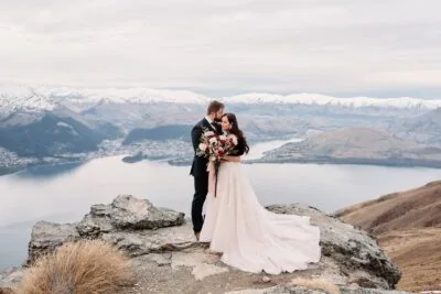 Queenstown New Zealand Elopement Wedding Photographer - A bride and groom standing on top of Cecil Peak, overlooking Lake Wanaka.
