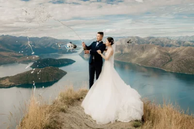 Queenstown New Zealand Elopement Wedding Photographer - A bride and groom standing on top of Coromandel Peak overlooking Lake Wanaka.