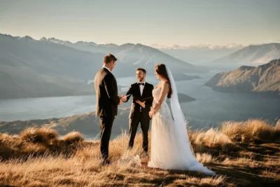 Queenstown New Zealand Elopement Wedding Photographer - A bride and groom standing on top of Coromandel Peak, overlooking lake Wanaka.
