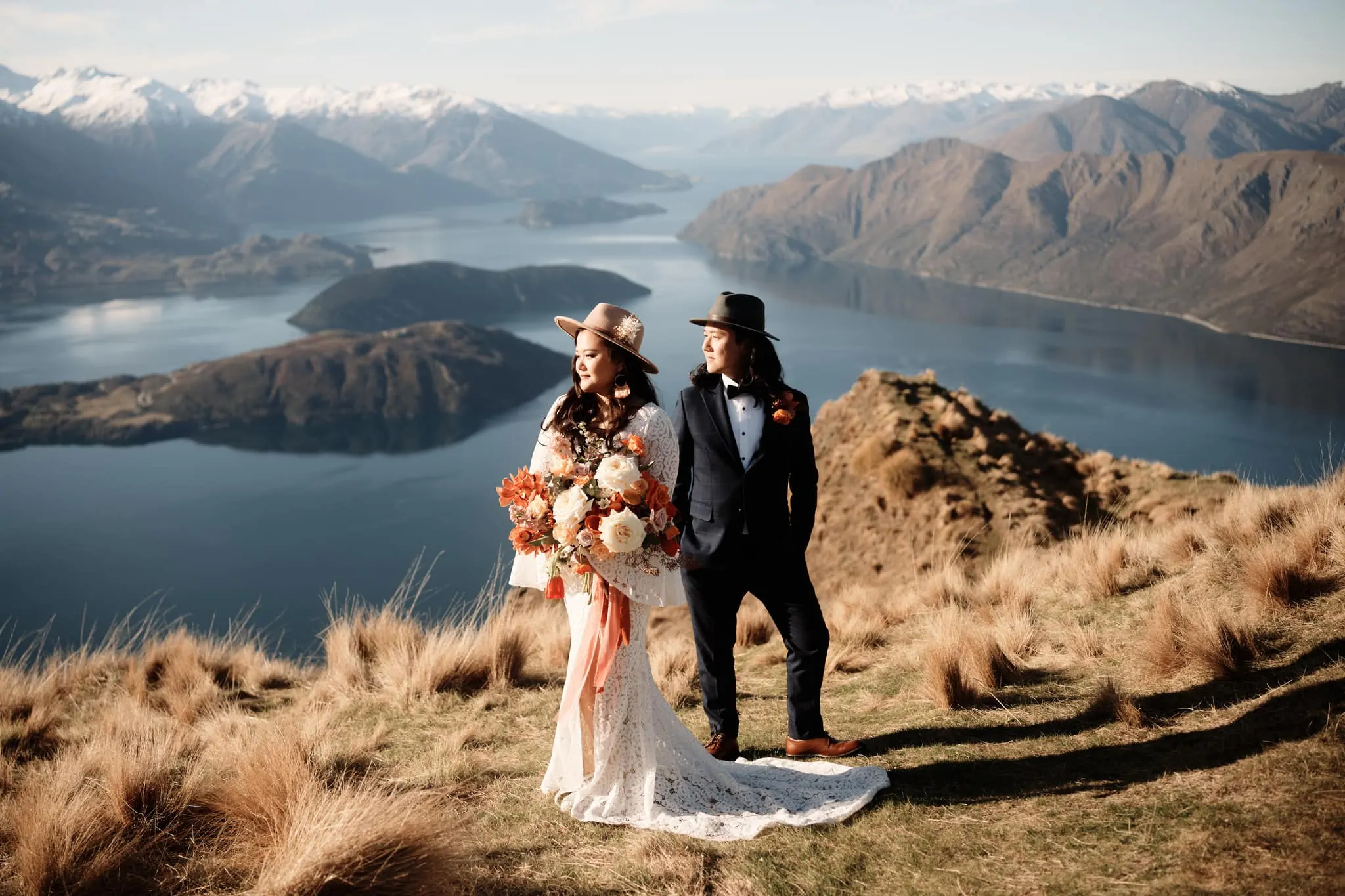 Queenstown New Zealand Elopement Wedding Photographer - Bride and groom standing on top of Coromandel Peak, overlooking lake Wanaka.