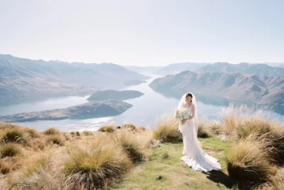 Queenstown New Zealand Elopement Wedding Photographer - A bride standing on top of Coromandel Peak overlooking lake wanaka.